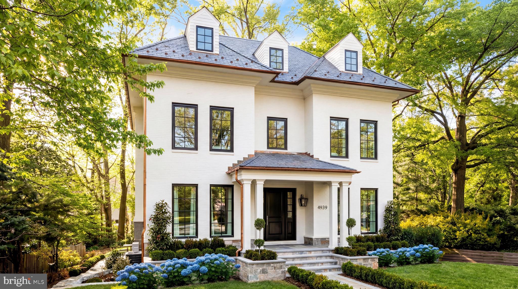 4939 Quebec Street Northwest Washington, DC 20016 - Photo 2 of 50 a front view of a house with garden