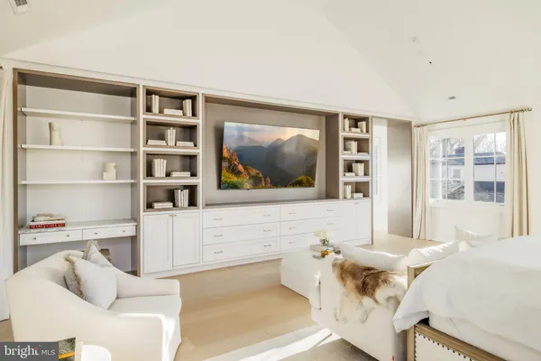 a kitchen with white cabinets and a window