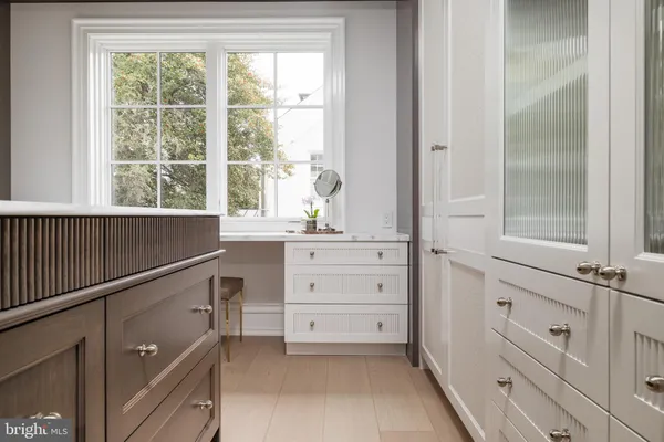 a bedroom with a bed and large windows