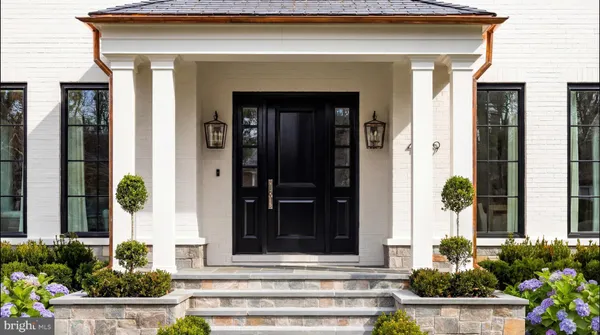 a front view of a house with potted plants
