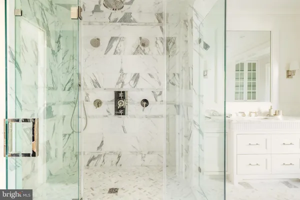 a bedroom with a bed and glass window