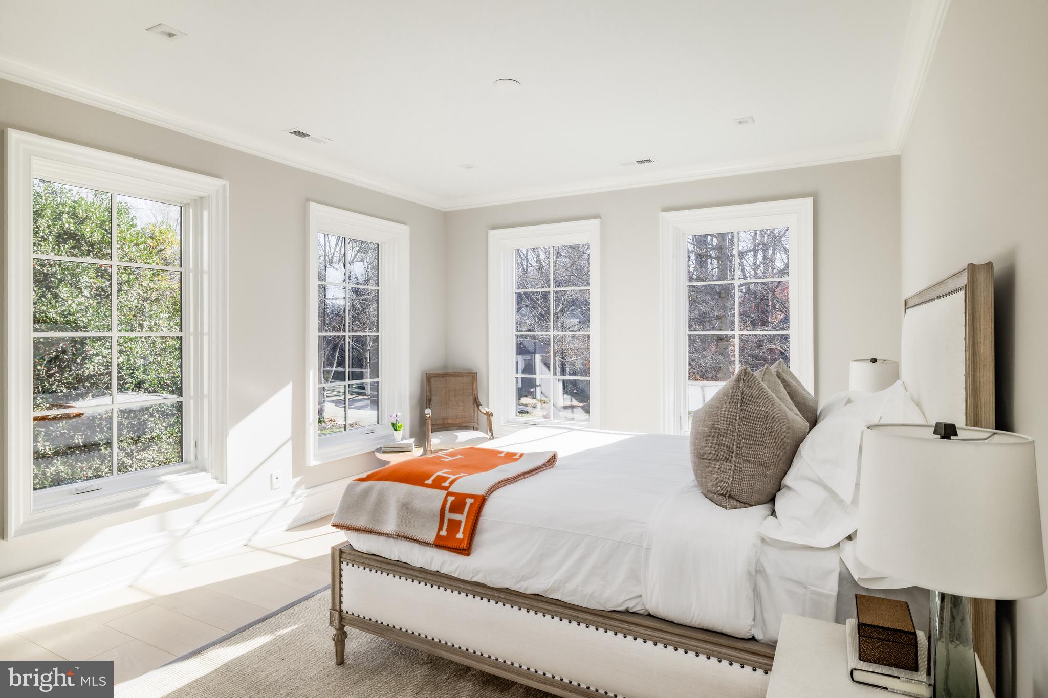 4939 Quebec Street Northwest Washington, DC 20016 - Photo 35 of 50 a bedroom with a bed and glass window
