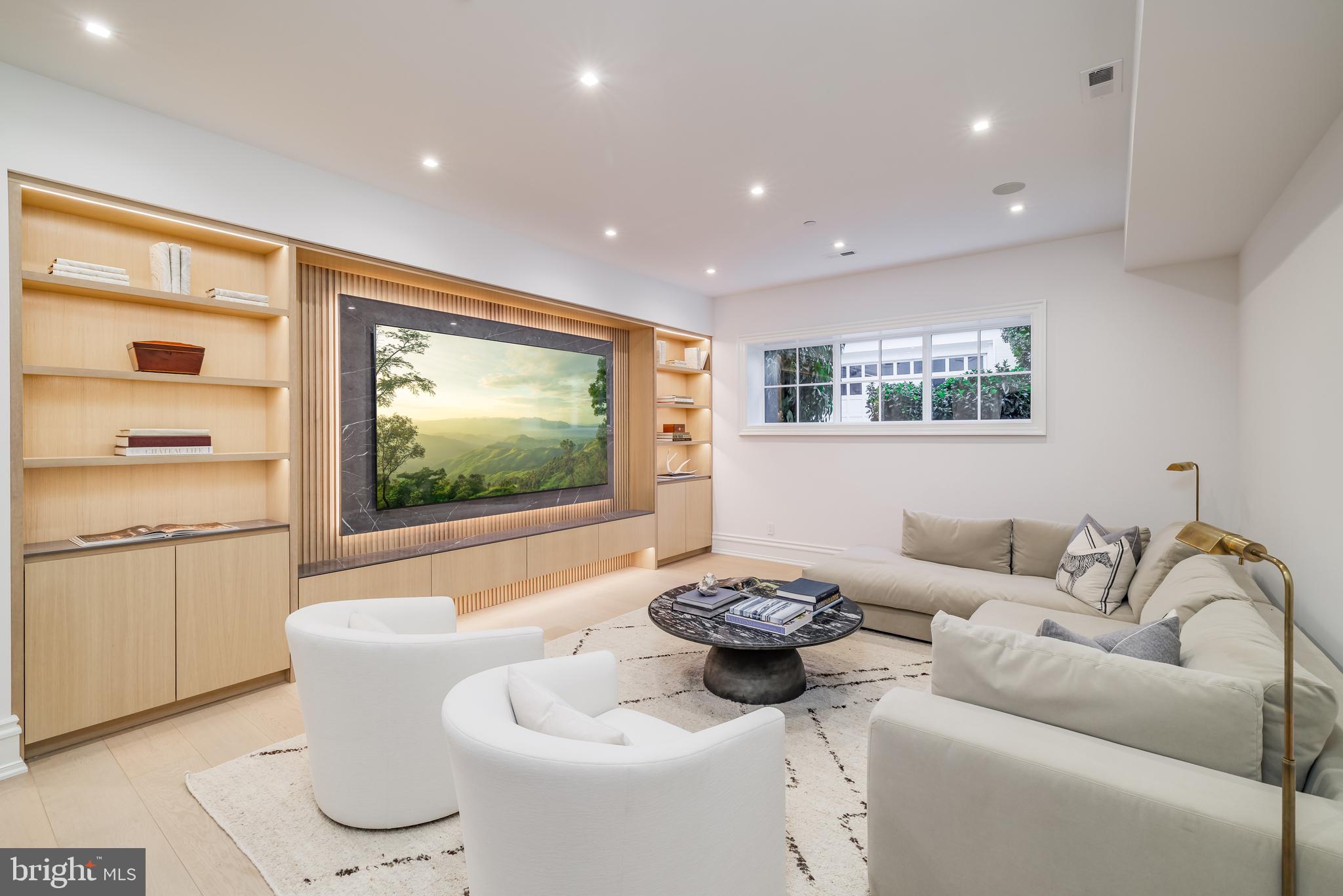 4939 Quebec Street Northwest Washington, DC 20016 - Photo 38 of 50 a living room with furniture and a flat screen tv