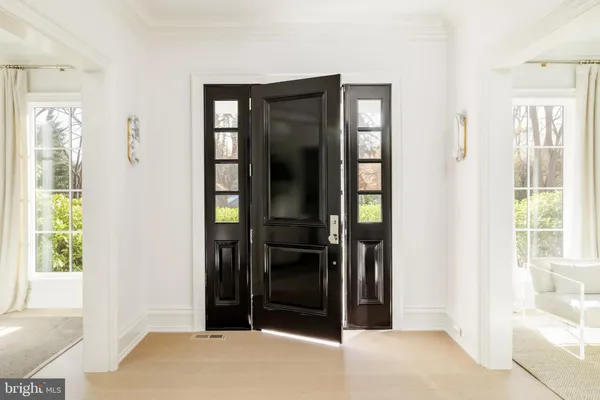 a view of an entryway with wooden floor and a livingroom