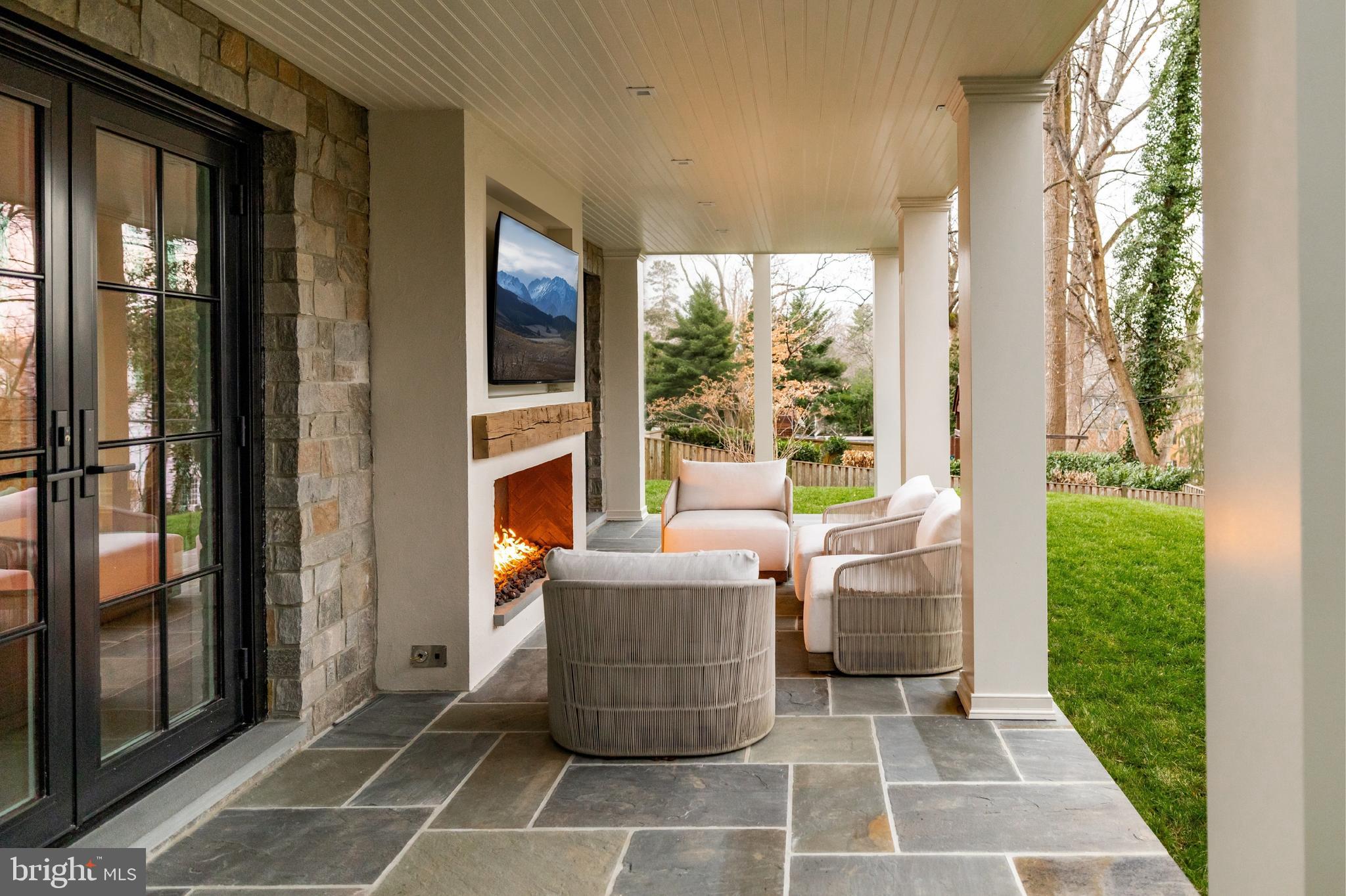 4939 Quebec Street Northwest Washington, DC 20016 - Photo 42 of 50 a living room with a couch and a floor to ceiling window