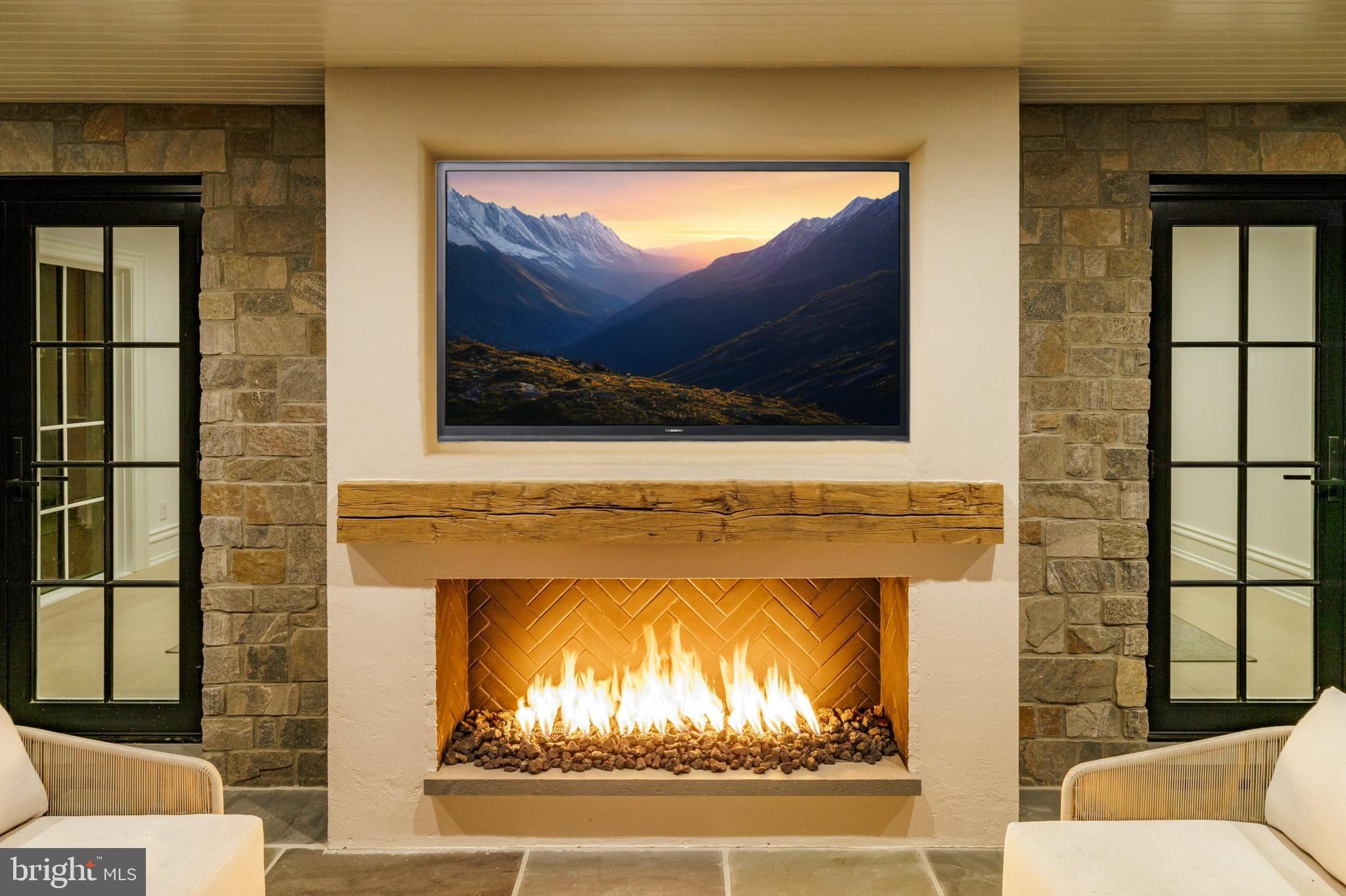 4939 Quebec Street Northwest Washington, DC 20016 - Photo 44 of 50 a living room with a fireplace and a flat screen tv