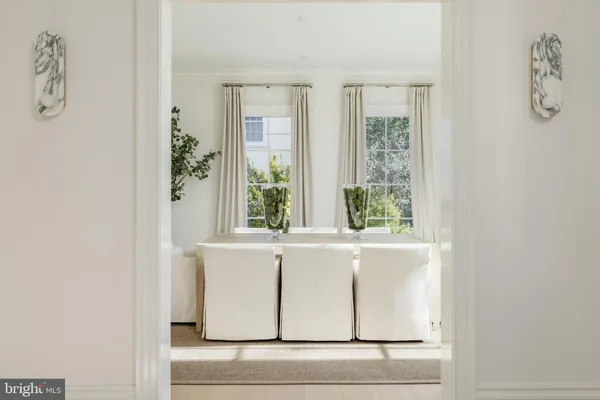 a white bath tub sitting in a room next to a window