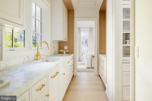 a kitchen with appliances a sink and cabinets