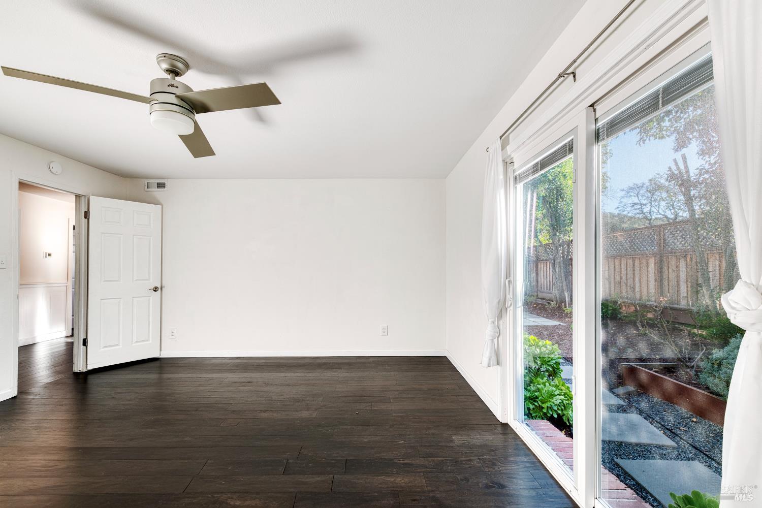 1534 Buchanan Street Novato, CA 94947 - Photo 11 of 30 a view of an empty room with wooden floor and a window