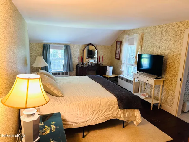 a bathroom with a sink a tub and a mirror