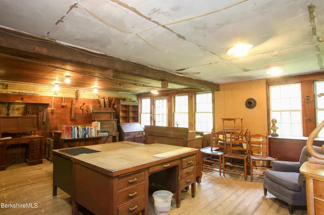 a backyard of a house with garden and outdoor seating