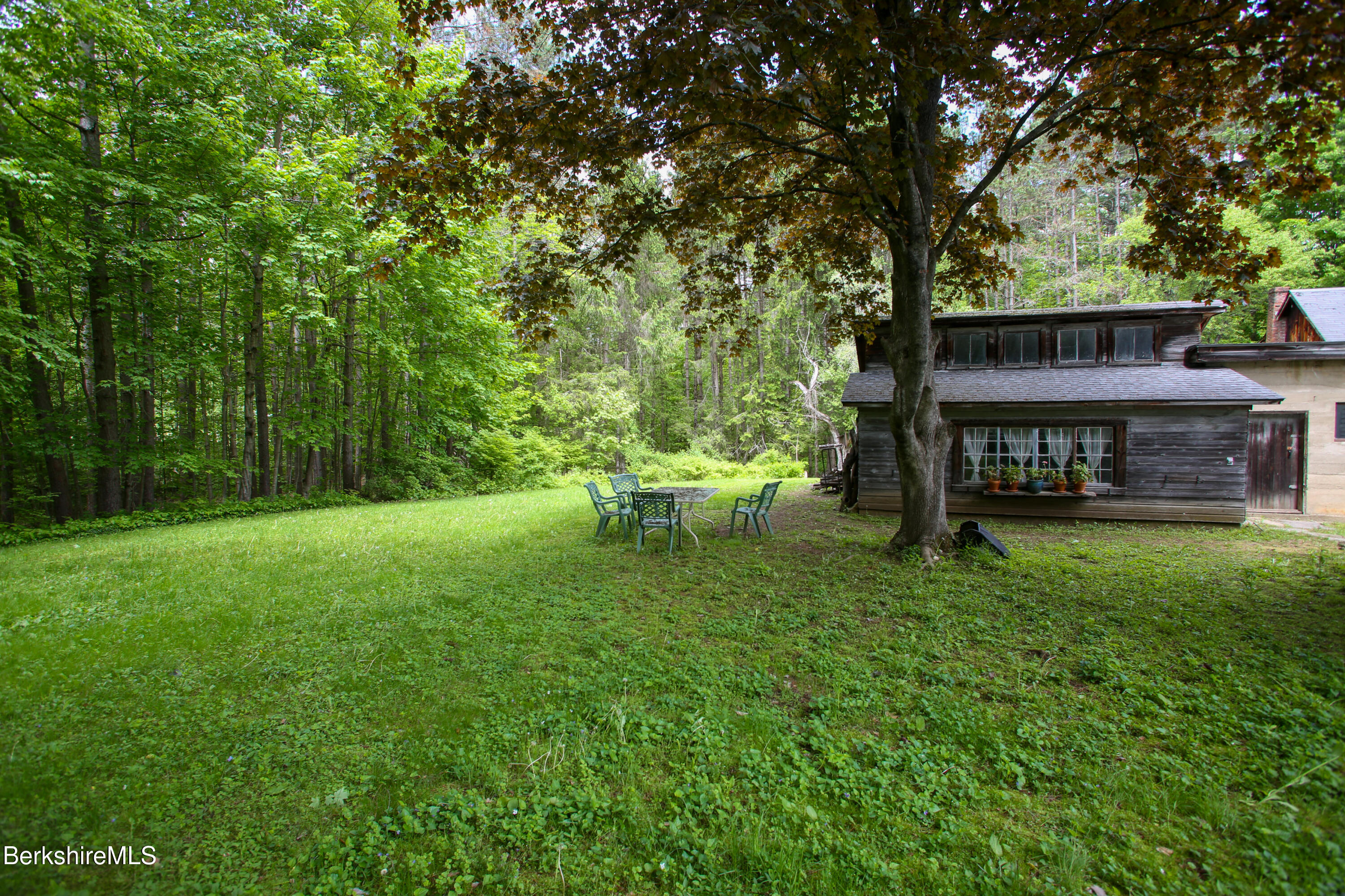 31 West Oxbow Road Charlemont, MA 01370 - Photo 36 of 39 a view of a wooden deck with a bench and trees