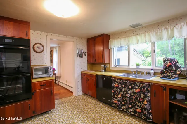 a dining room with furniture a window and a chandelier