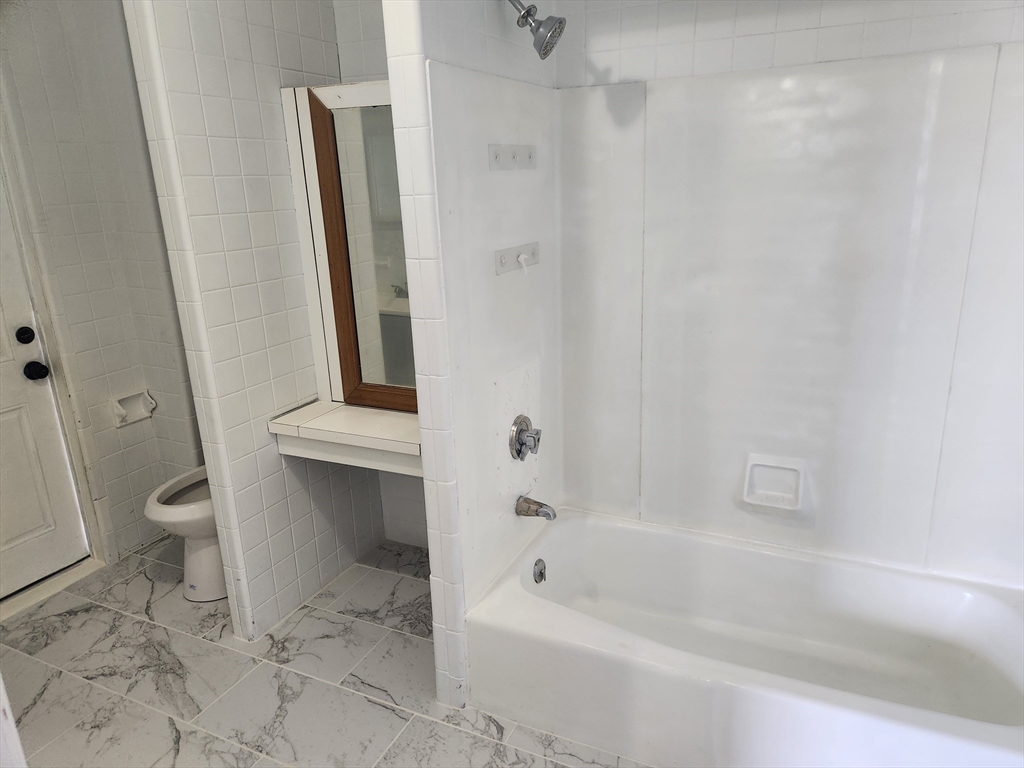 51 Everett Street, Unit 3 Everett, MA 02149 - Photo 3 of 4 a bathroom with a bathtub a toilet and a shower
