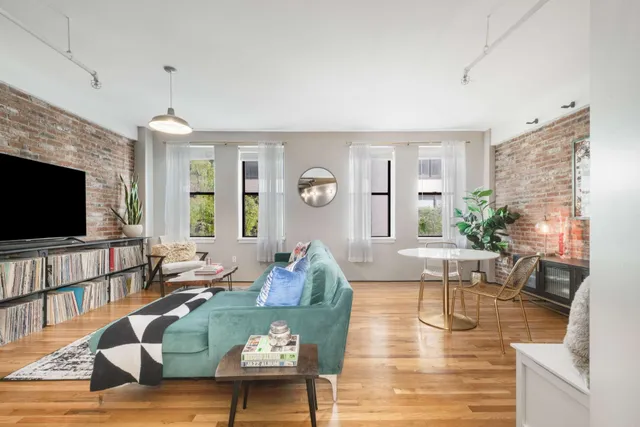 a living room with fireplace furniture and a flat screen tv