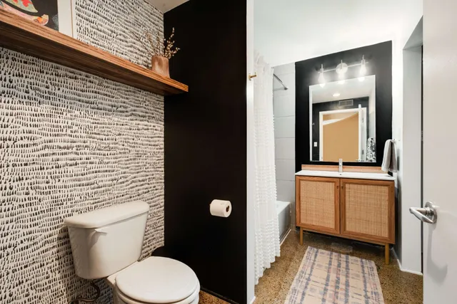 a bathroom with a toilet and a sink