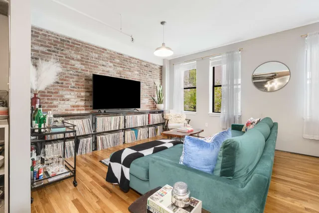 a living room with furniture fireplace and flat screen tv