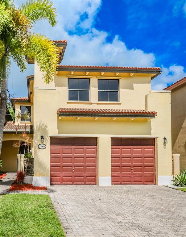 22808 Southwest 89th Path Cutler Bay, FL 33190 - Photo 2 of 35 a front view of a house with a yard and garage