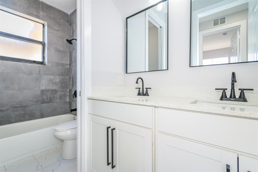 22808 Southwest 89th Path Cutler Bay, FL 33190 - Photo 23 of 35 a bathroom with a sink a toilet and a mirror