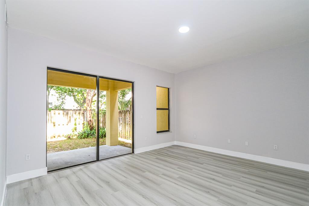 22808 Southwest 89th Path Cutler Bay, FL 33190 - Photo 8 of 35 a view of an empty room with wooden floor and a window
