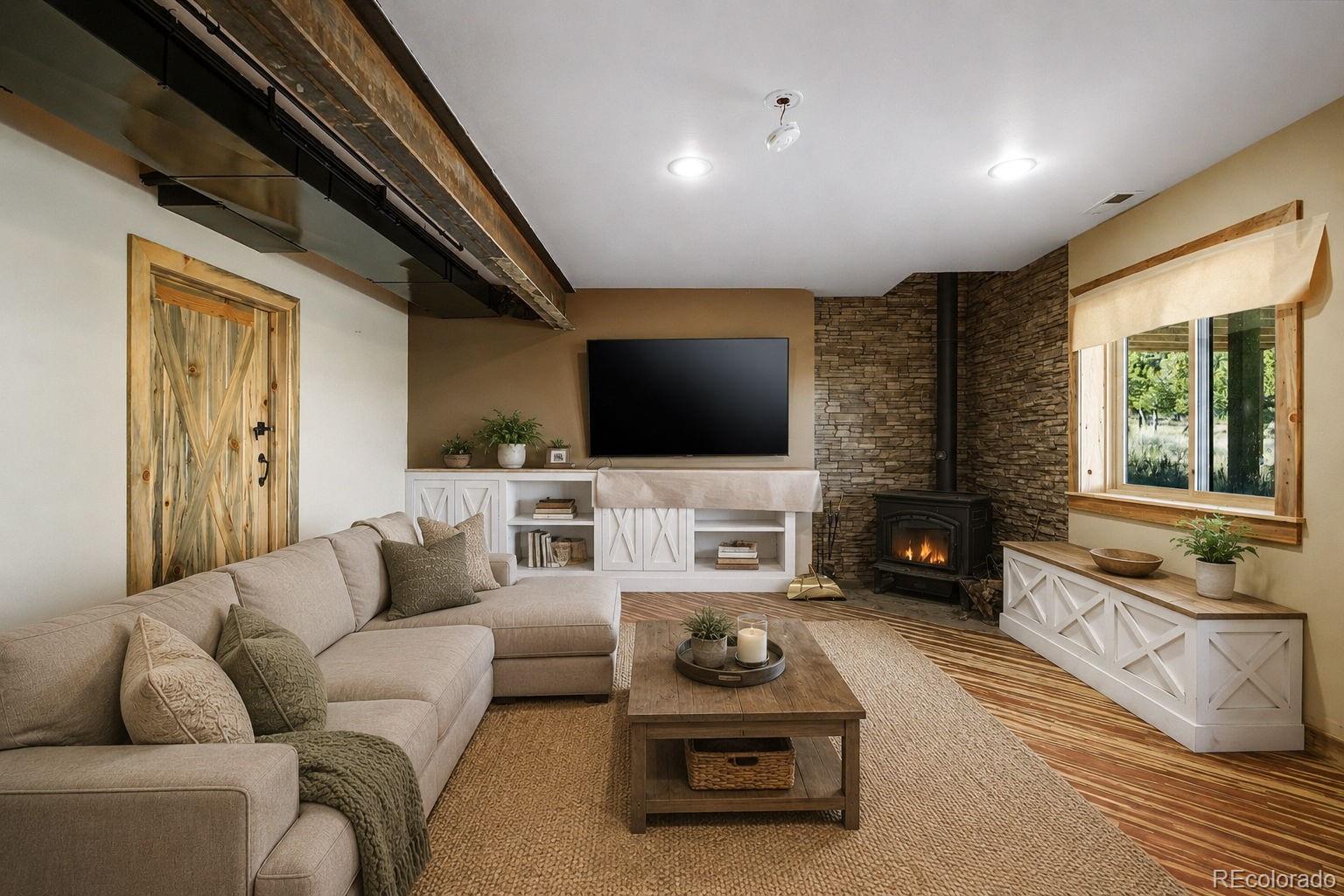 2925 Siloam Road Pueblo, CO 81005 - Photo 26 of 44 a living room with furniture a flat screen tv and a fireplace