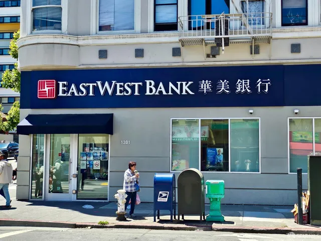 a front view of multi story building with retail shop and windows