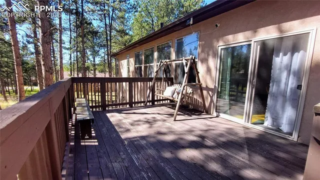 a view of a hallway with wooden floor and windows