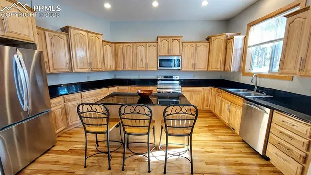 a bedroom with a large bed and windows