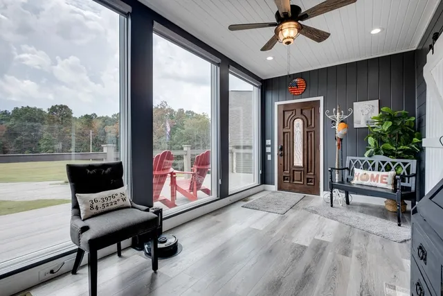 a dining table with chairs and kitchen view