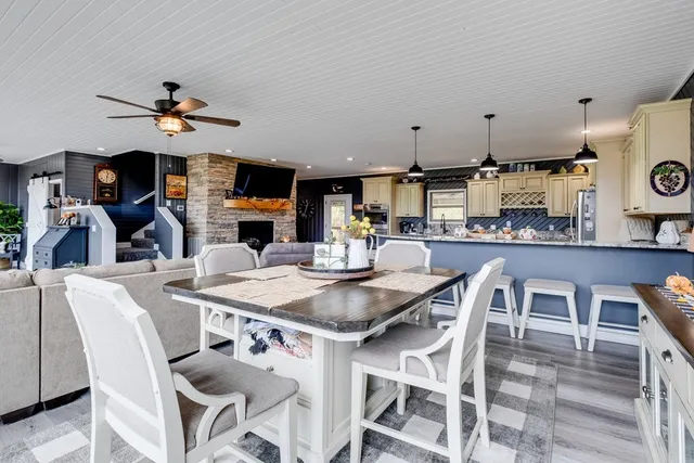 a kitchen with stainless steel appliances granite countertop a sink a stove and a wooden cabinets