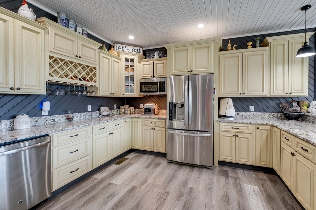4700 Honey Creek Loop Road Allardt, TN 38504 - Photo 19 of 70 a kitchen with granite countertop appliances cabinets and a sink