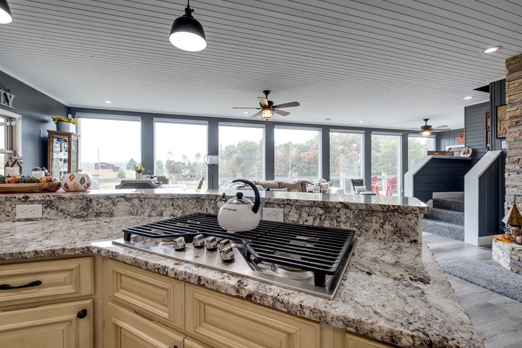 4700 Honey Creek Loop Road Allardt, TN 38504 - Photo 21 of 70 a kitchen with stainless steel appliances granite countertop a sink a stove and a wooden cabinets