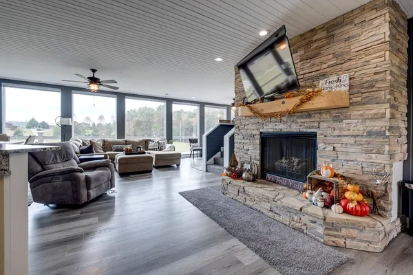 a view of an empty room with a fireplace and a window