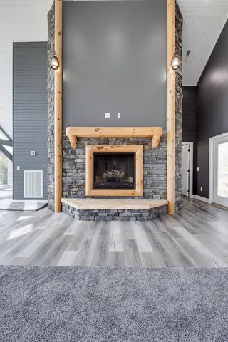 a spacious bedroom with a bed and a chandelier