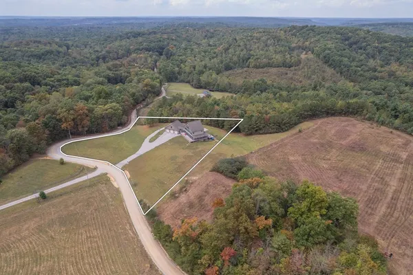an aerial view of a house with a yard