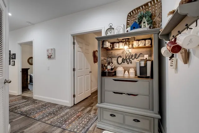 a front view of a house with a garden and trees