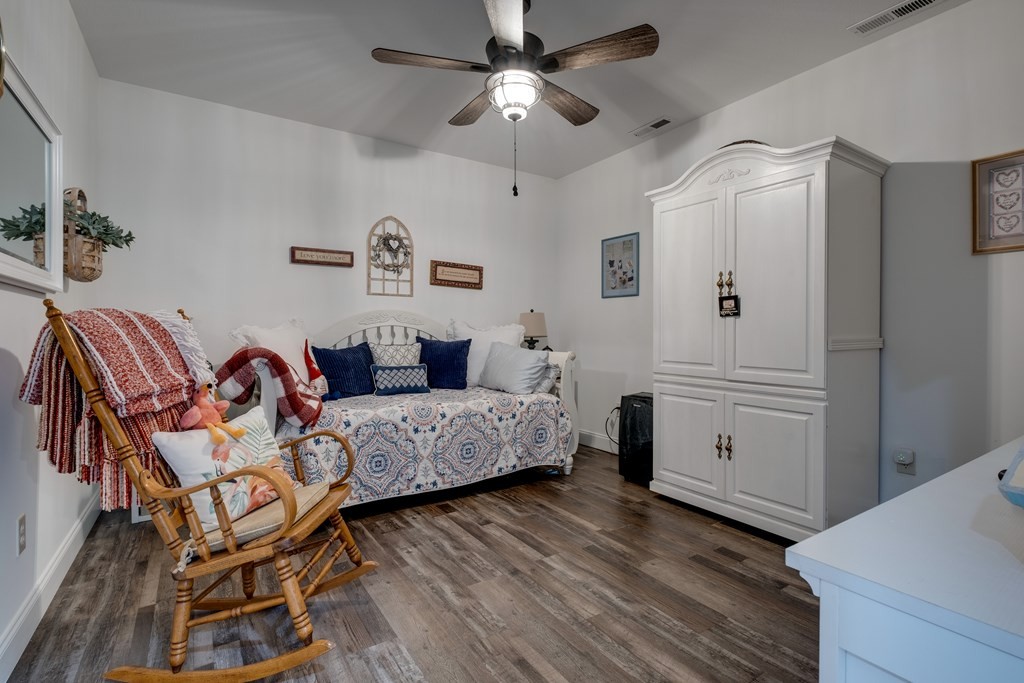 4700 Honey Creek Loop Road Allardt, TN 38504 - Photo 38 of 70 a spacious bedroom with a bed and a chandelier