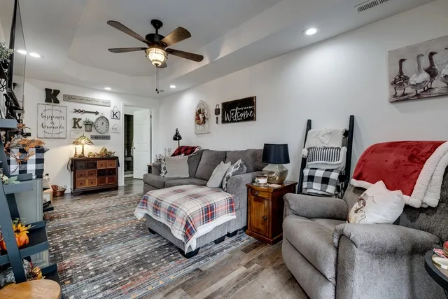 a bedroom with a bed a couch and a chandelier