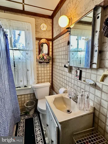a bathroom with a sink mirror vanity and toilet