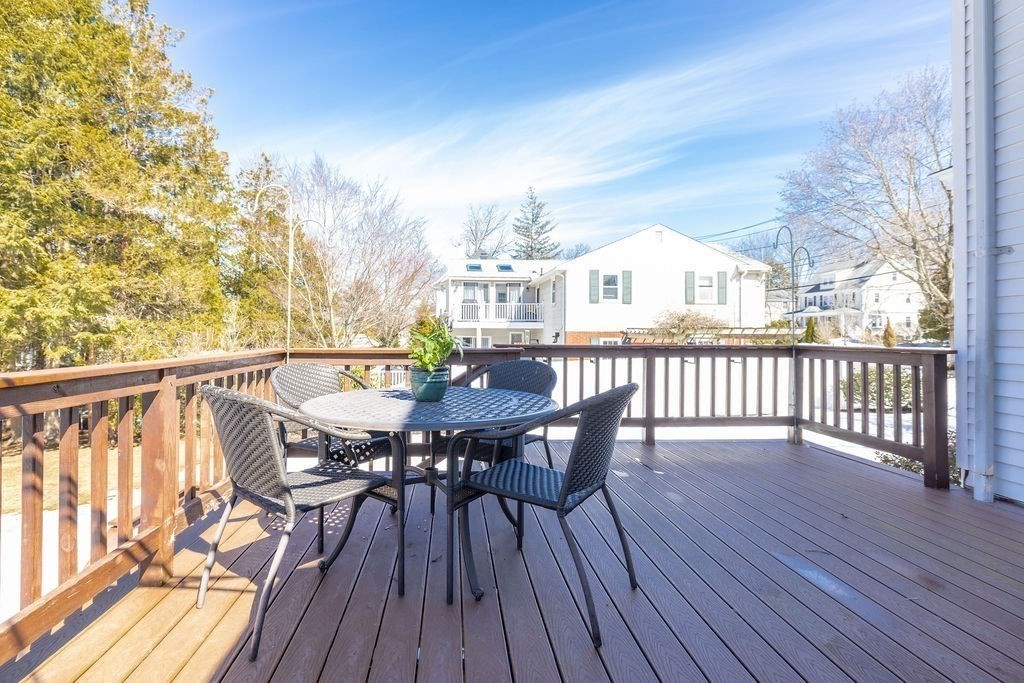 60 High Street Needham, MA 02494 - Photo 29 of 32 a view of a roof deck with table and chairs and wooden floor