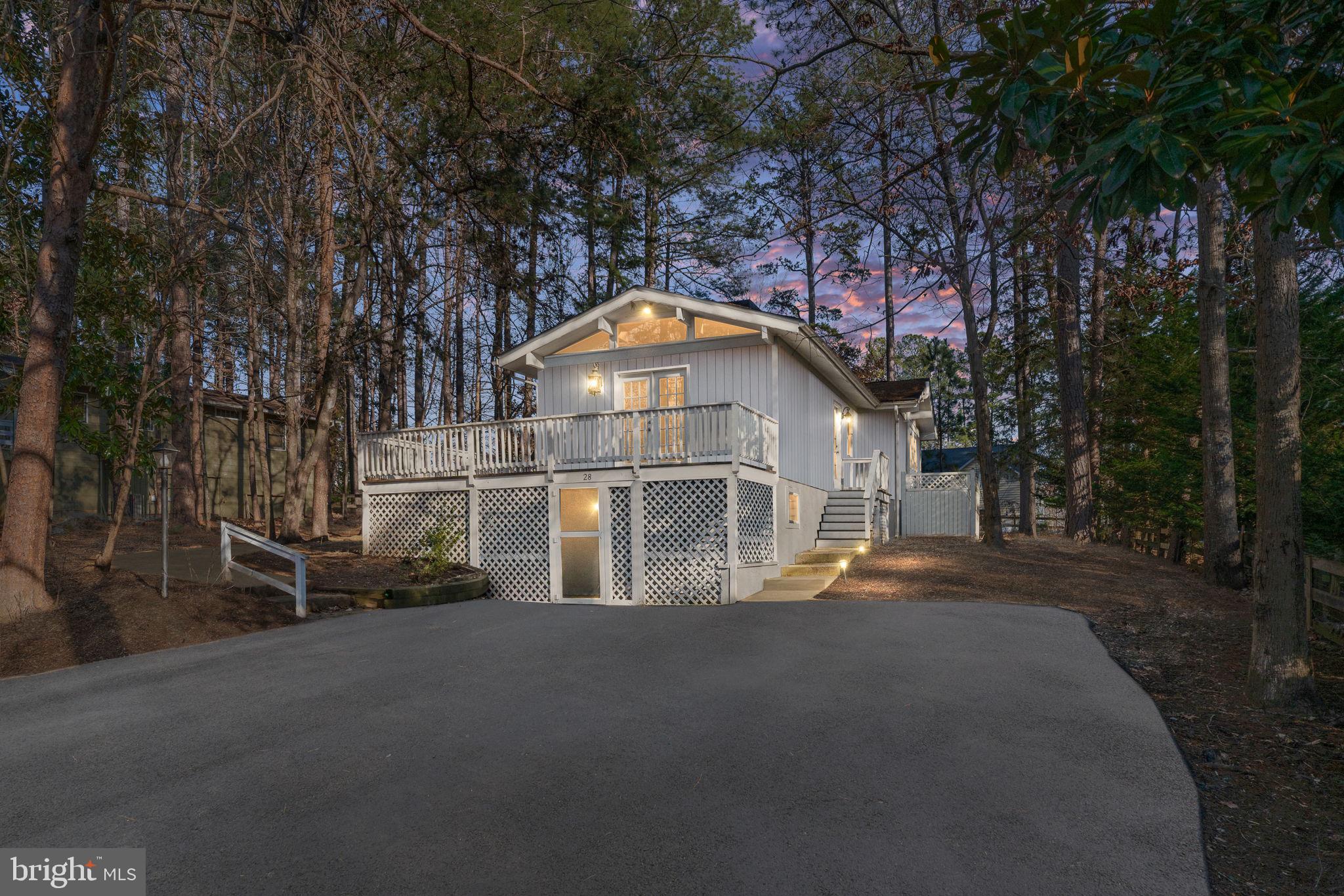 a front view of a house with a street