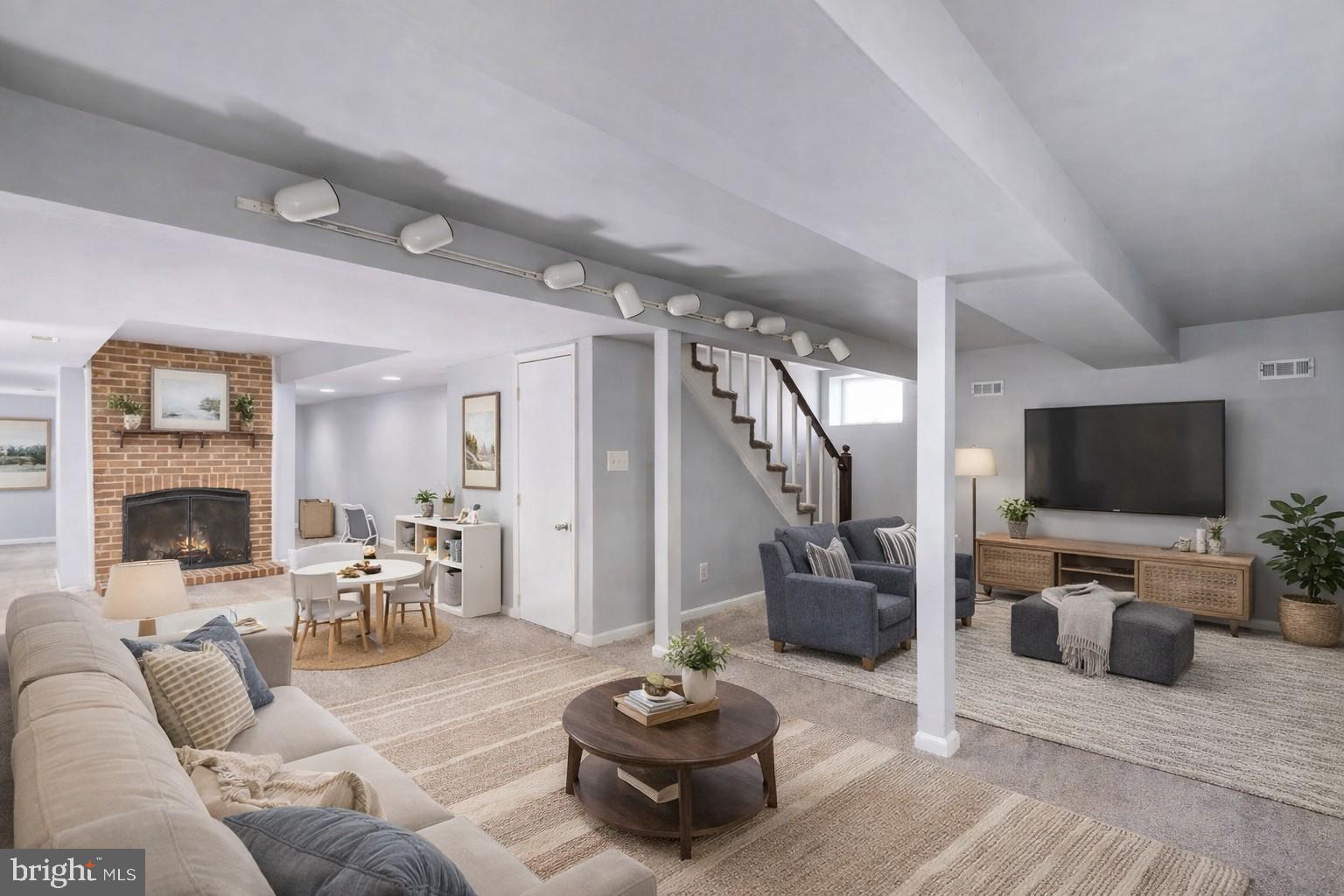 28 Tanglewood Road Palmyra, VA 22963 - Photo 15 of 44 a living room with furniture a flat screen tv and a fireplace