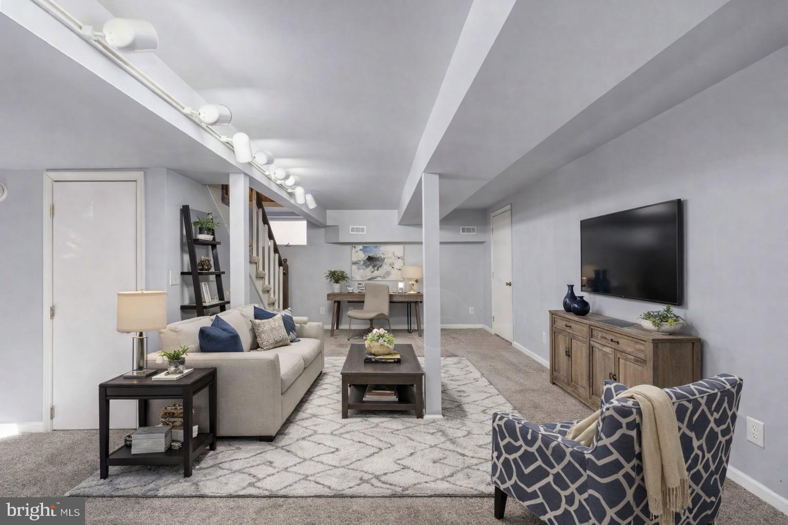 28 Tanglewood Road Palmyra, VA 22963 - Photo 16 of 44 a living room with furniture and a flat screen tv