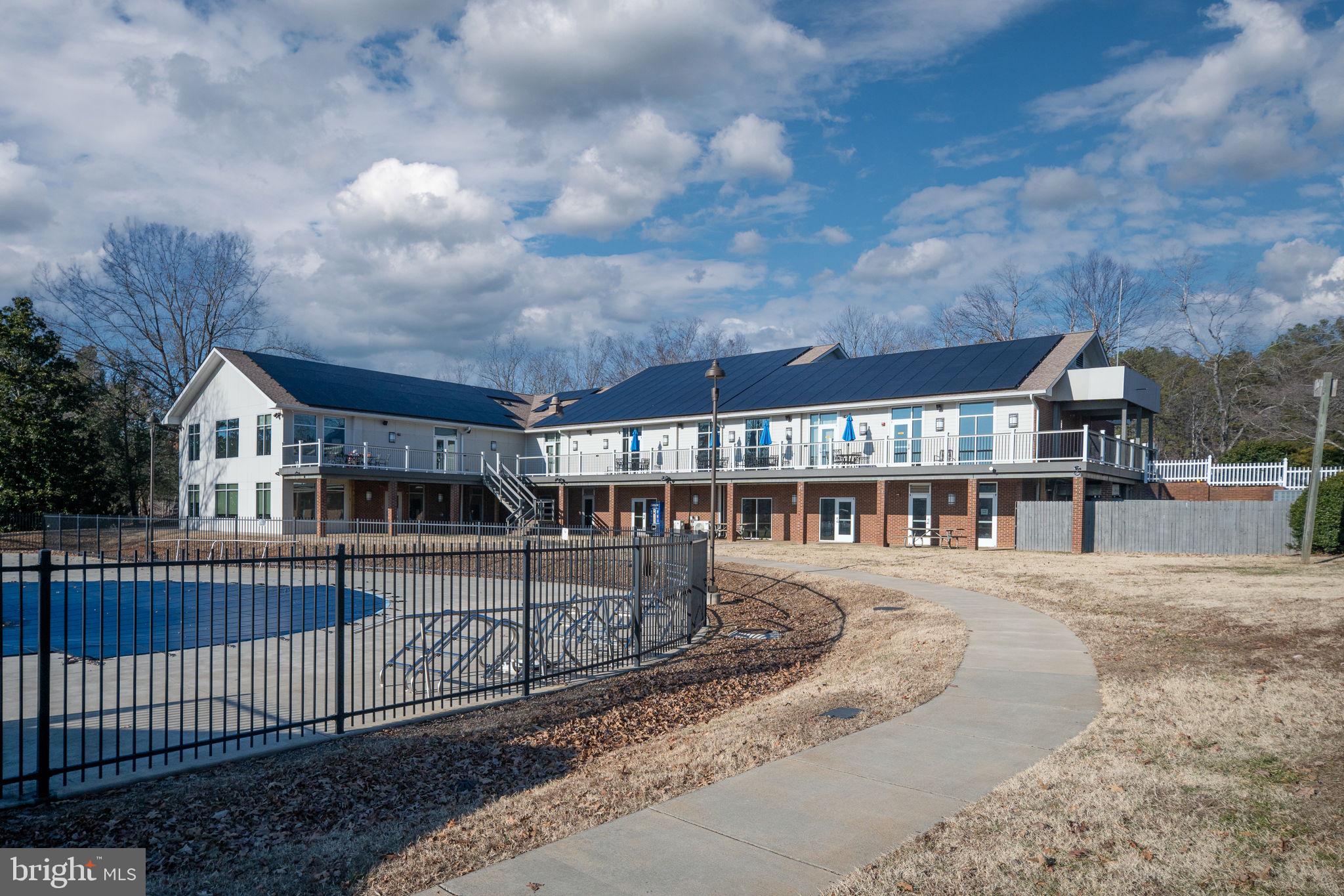 28 Tanglewood Road Palmyra, VA 22963 - Photo 23 of 44 a view of a brick house with large windows and a yard