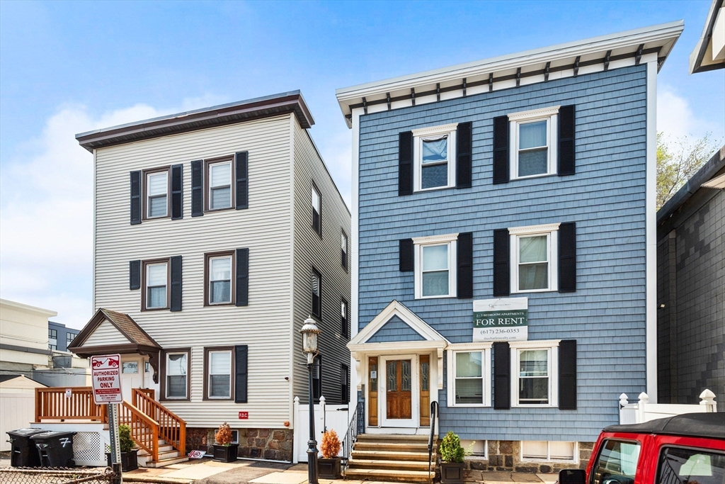 a front view of a residential apartment building with a yard