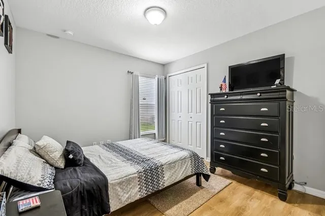 a bedroom with a bed and a television