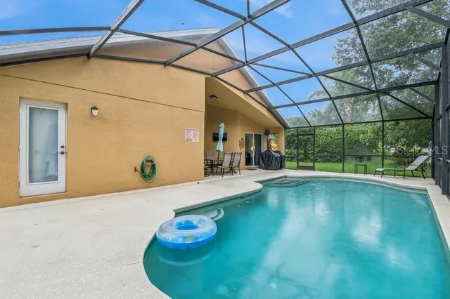 a view of a swimming pool with a yard