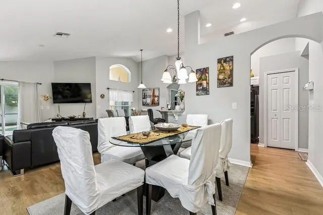 a dining room with furniture window and wooden floor
