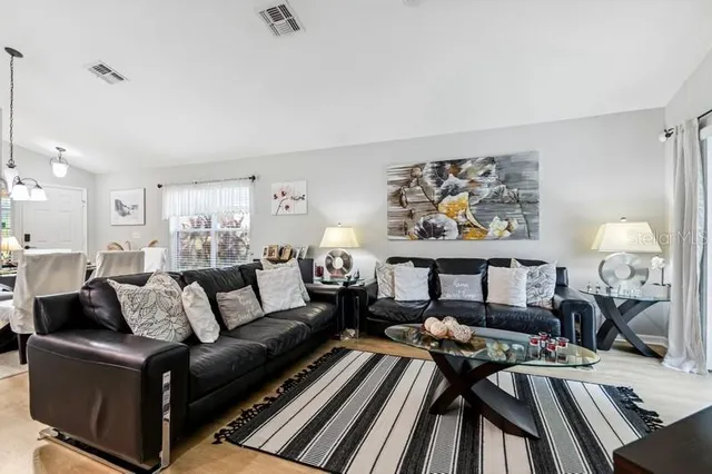 a living room with furniture and a chandelier