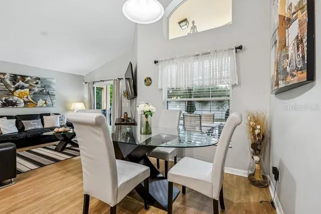 a view of a dining room with furniture window and wooden floor